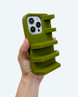 Sage green Geta phone case in a hand on a white background