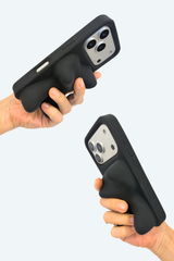 Two hands holding black phone cases with integrated ergonomic grips, shown against a light gray background.