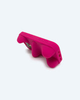 Pink sculptural phone case on its side