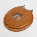 closed wooden toilet seat with the back of the ear showing
