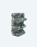 Decorative stone with a speckled pattern on a white background