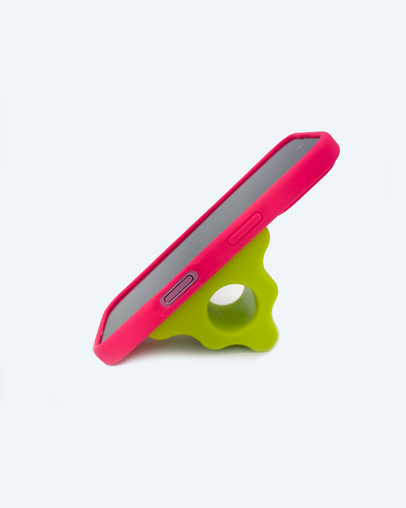 Pink phone case with a green phone stand on a white background