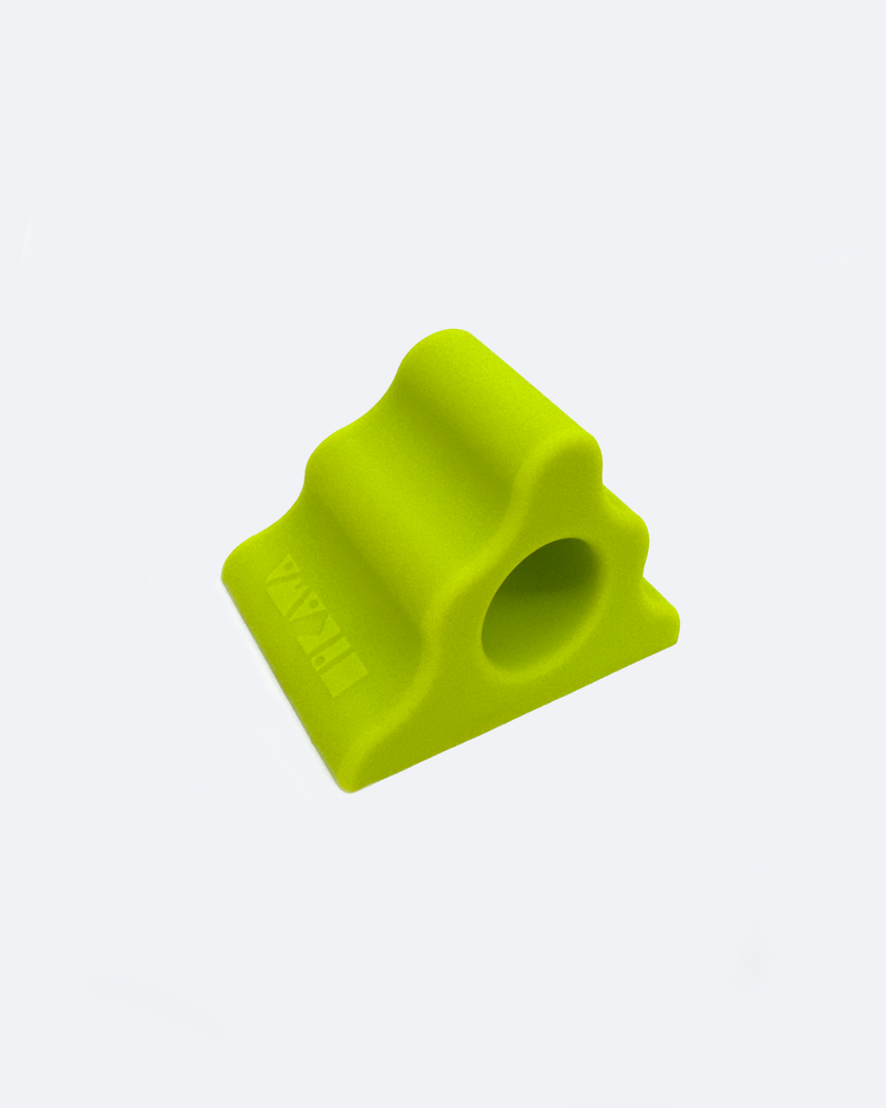 Yellow silicone phone stand and tool on a white background