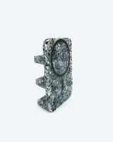 Speckled gray phone stand on a white background