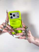 Person holding a phone with a neon green case against a white background