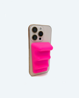 Phone with a pink sticky note holder on a white background
