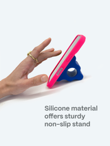 Hand touching a phone with a pink case on a blue stand against a white background